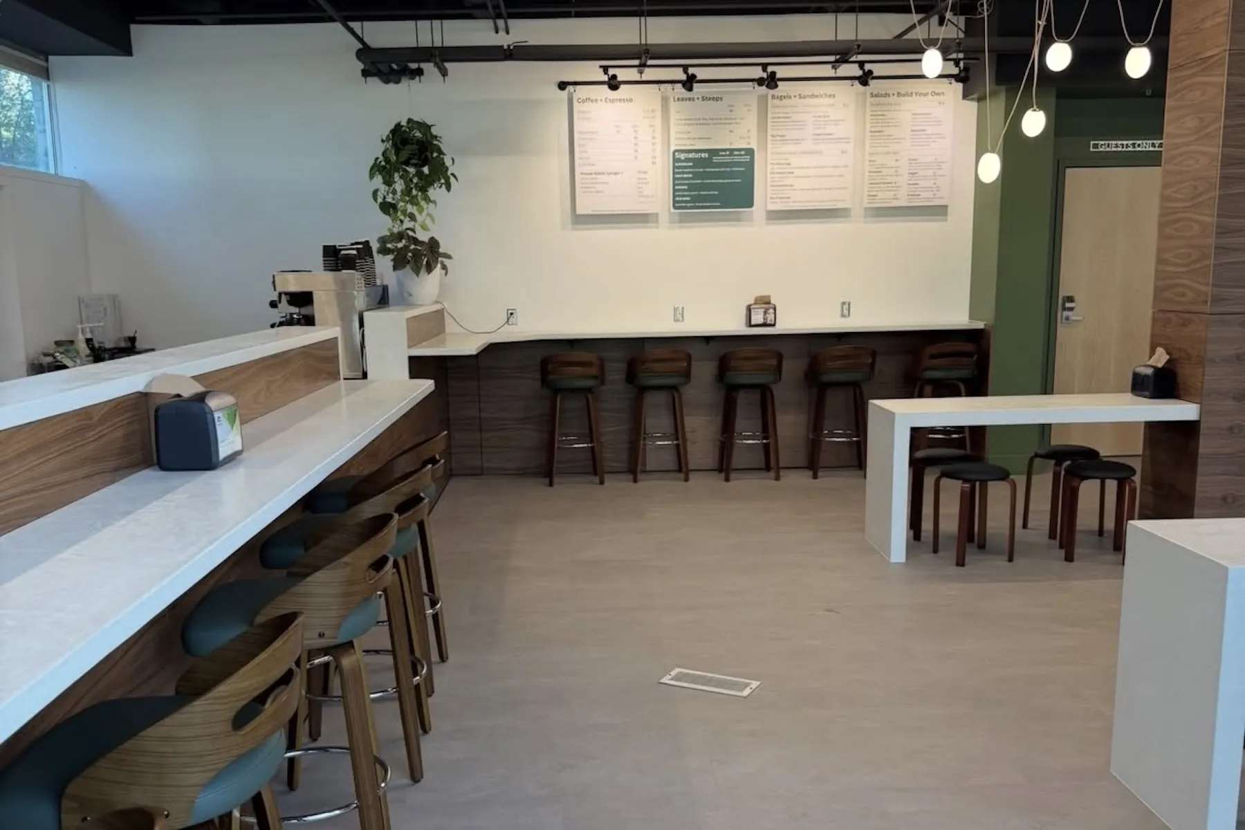 Café seating with white bar tops and a wall-mounted counter