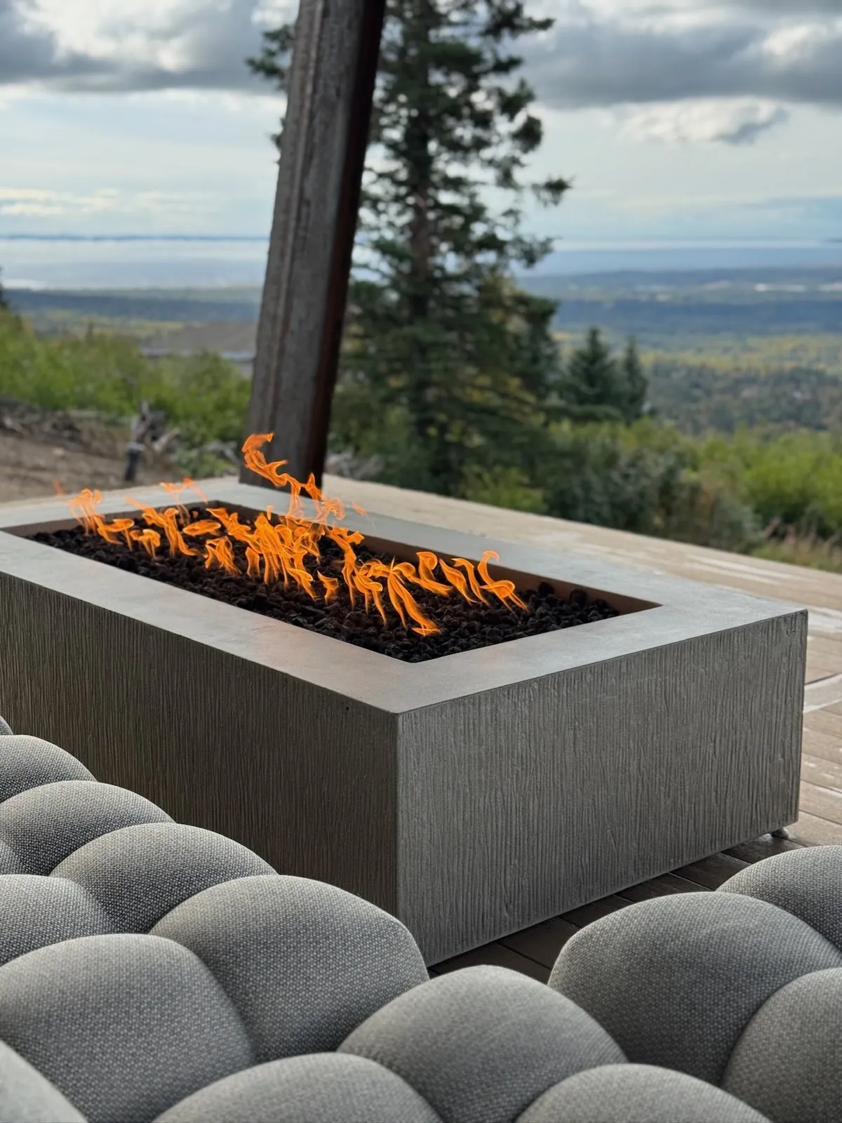 Concrete fire table on a patio at dusk
